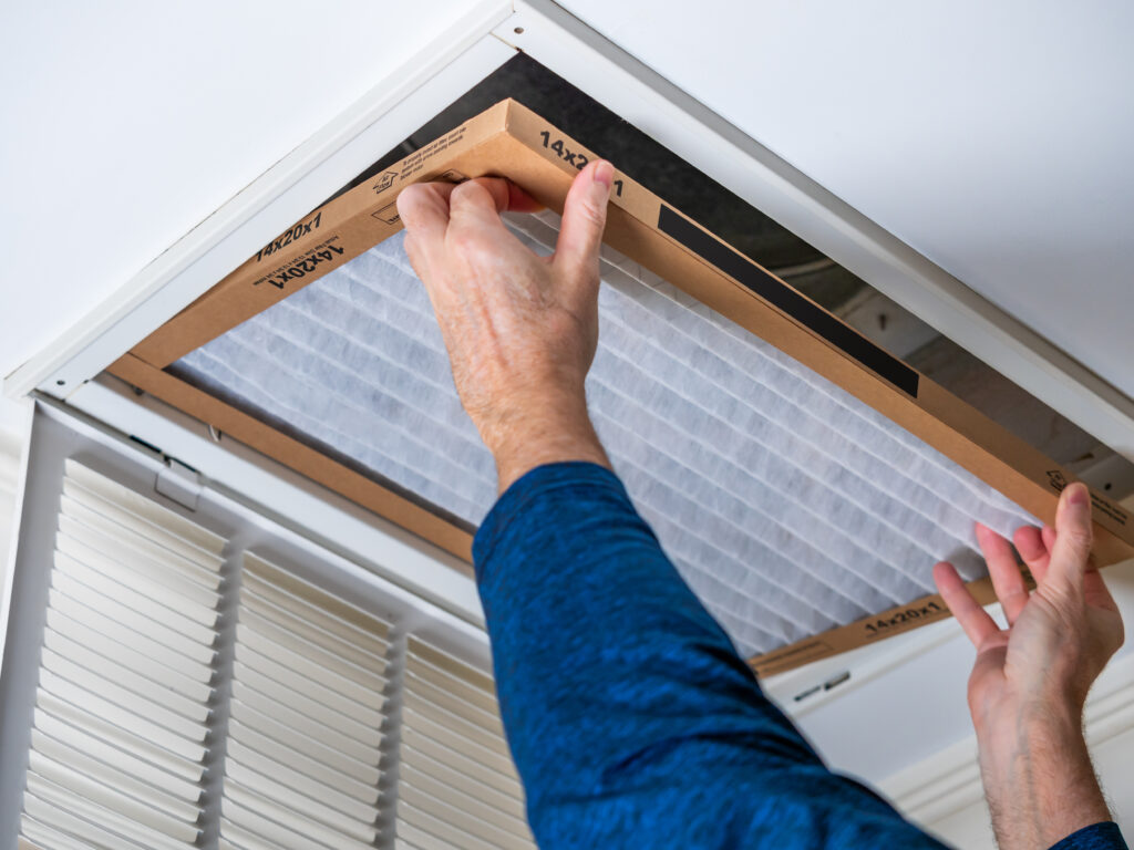 HVAC technician replacing a home air filter in Rancho Palos Verdes