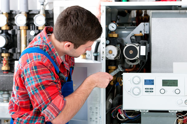 Heating technician repairing boiler controls in Rancho Palos Verdes