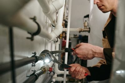 Technician inspecting commercial plumbing pipes in Rancho Palos Verdes
