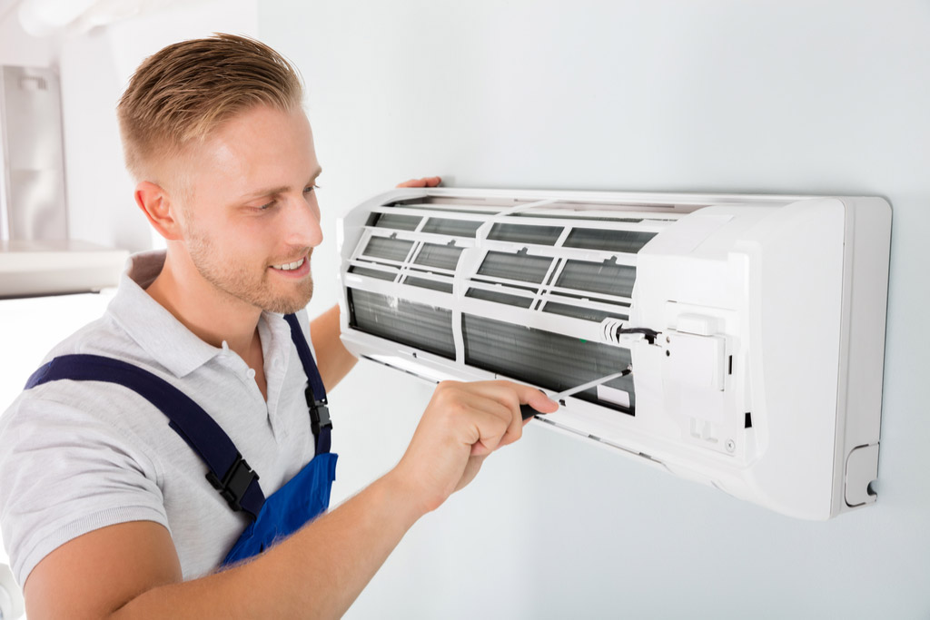 HVAC technician maintaining a ductless air conditioner in Rancho Palos Verdes