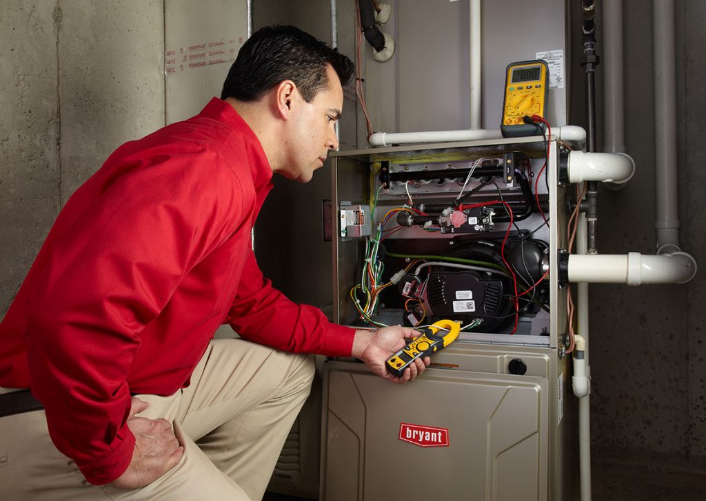 Heating technician diagnosing a furnace repair in Rancho Palos Verdes