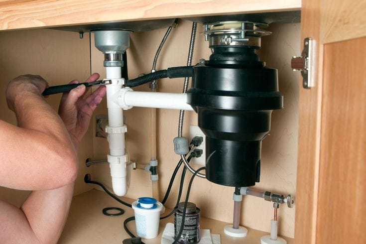 Plumber repairing a garbage disposal in Rancho Palos Verdes