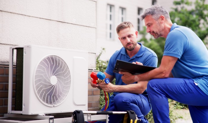 HVAC technicians installing an outdoor air conditioning unit in Rancho Palos Verdes