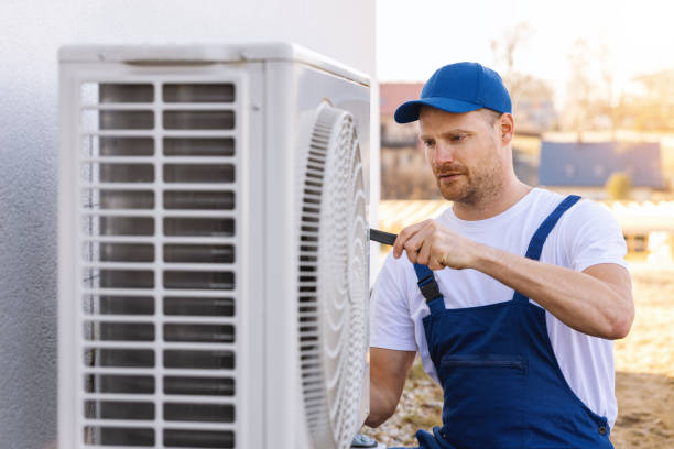 HVAC technician servicing an outdoor air conditioner in Rancho Palos Verdes